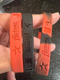 set of three mylar wristbands bracelets featuring the logo of the Houston Astros, a Major League Baseball team. Made by Forever Collectibles