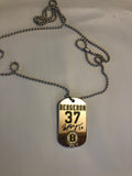 Boston Bruins NHL former team captain Patrice Bergeron metal dog tag necklace with engraved signature.