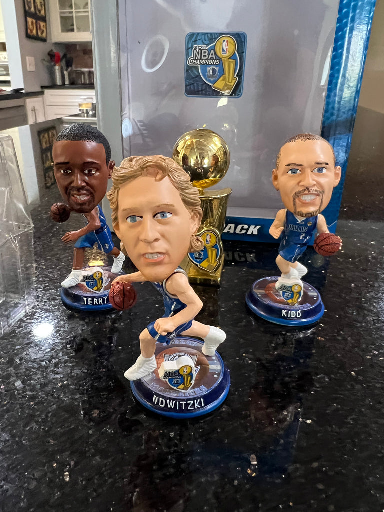 mini bobblehead set featuring Dirk Nowitzki of the Dallas Mavericks, a team that won the NBA championship in 2011.