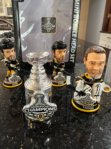The Boston Bruins 2001 Stanley Cup Champions Mini Bobblehead Set is a collectible item featuring the team members Chara and Thomas and Lucic
