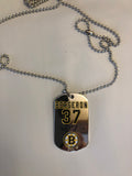 Boston Bruins NHL former team captain Patrice Bergeron metal dog tag necklace with engraved signature.