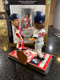 The Boston Red Sox MLB Jason Varitek & Curt Schilling Duel Ticket Base Bobblehead is a limited edition collectible commemorating